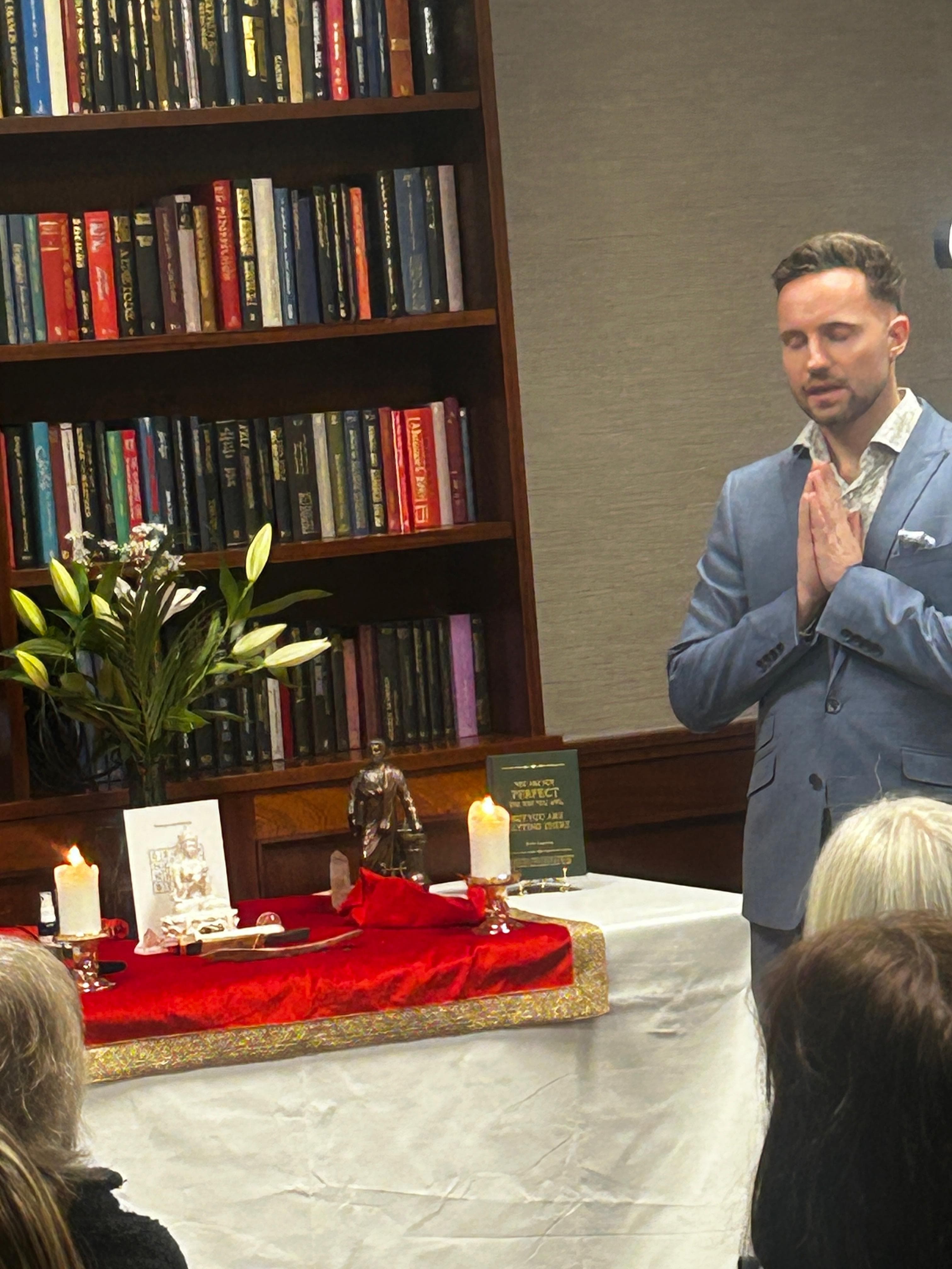 Marian conducting a sacred ceremony with his book